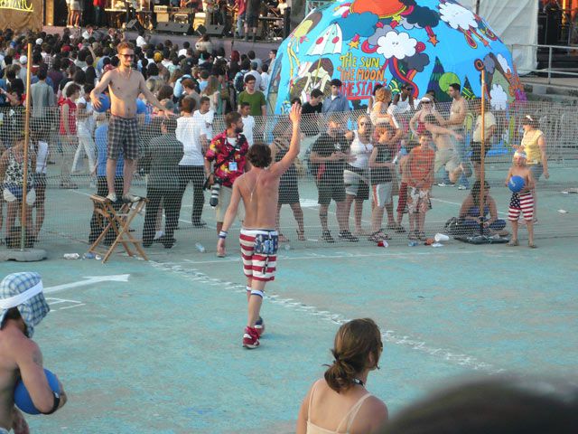 Old Glory Shorts (the dodgeball captain formerly known as Corona Shorts) waves farewell after being eliminated from the last McCarren Pool dodgeball game ever, as his mini-me looks on.